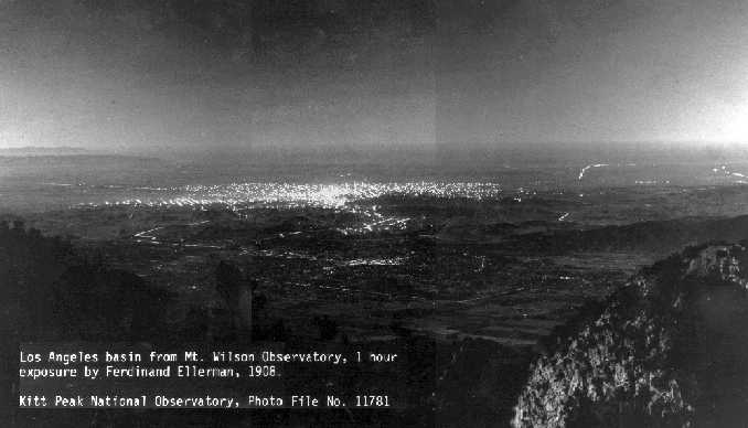 Black and white historic aerial photo of the Los Angeles Basin at night in 1908 showing sparse city lights.