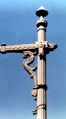 Close-up of an ornamental 1930s cast iron bracket with a dragon-head motif.
