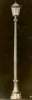 Studio-style shot of a single rectangular lantern on a slender fluted post.